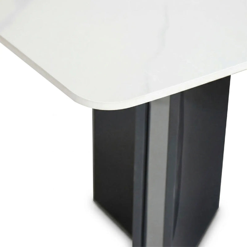 Close-up of a table corner with white top and black base