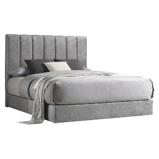 Gray upholstered bed with pillows and a blanket on a white background