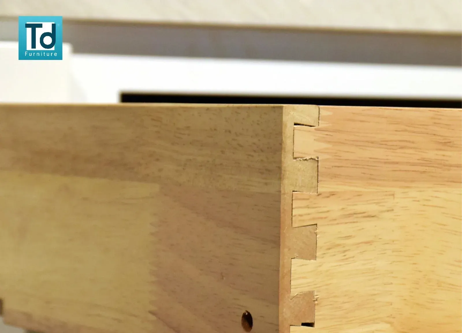Solid wood dovetail joint at the corner of a drawer box