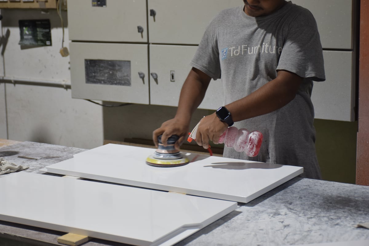 Skilled craftsman assembling a sofa frame at TD Furniture's sofa division.