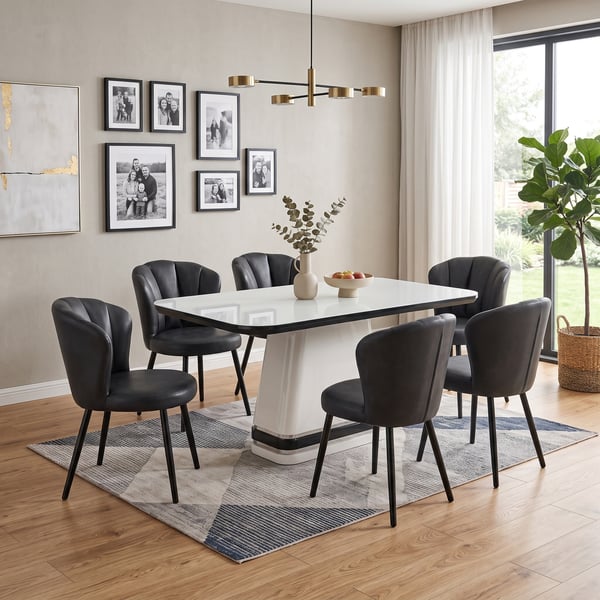 Round dining table set with upholstered chairs.