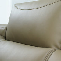 Close-up of a beige leather sofa with stitching details.