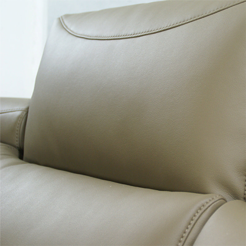 Close-up of a beige leather sofa with stitching details.