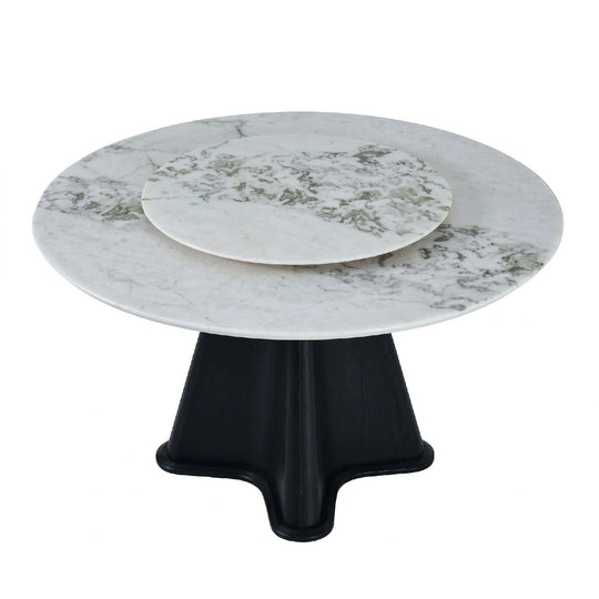 Round marble table with a black base on a white background