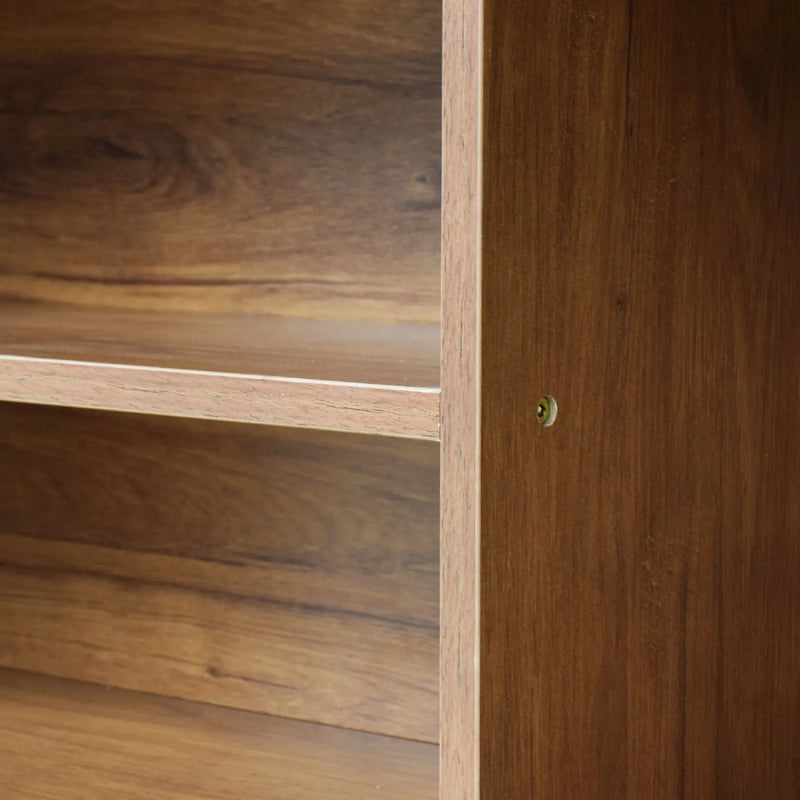 Close-up of a wooden cabinet with a door open, revealing shelves.
