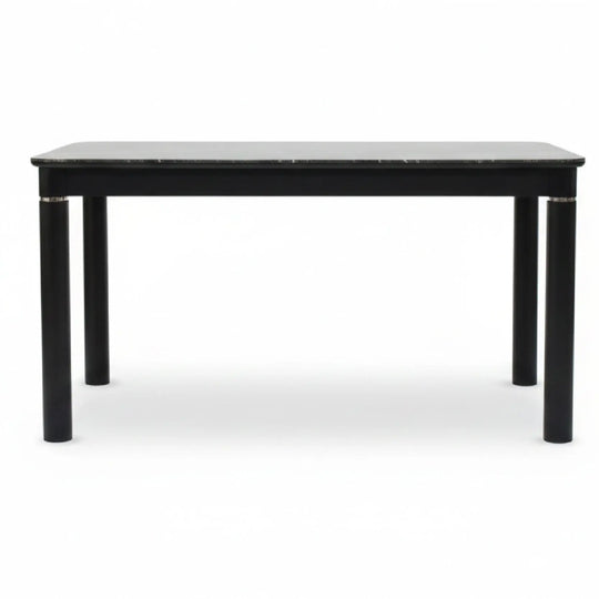 Black dining table with marble top on a white background