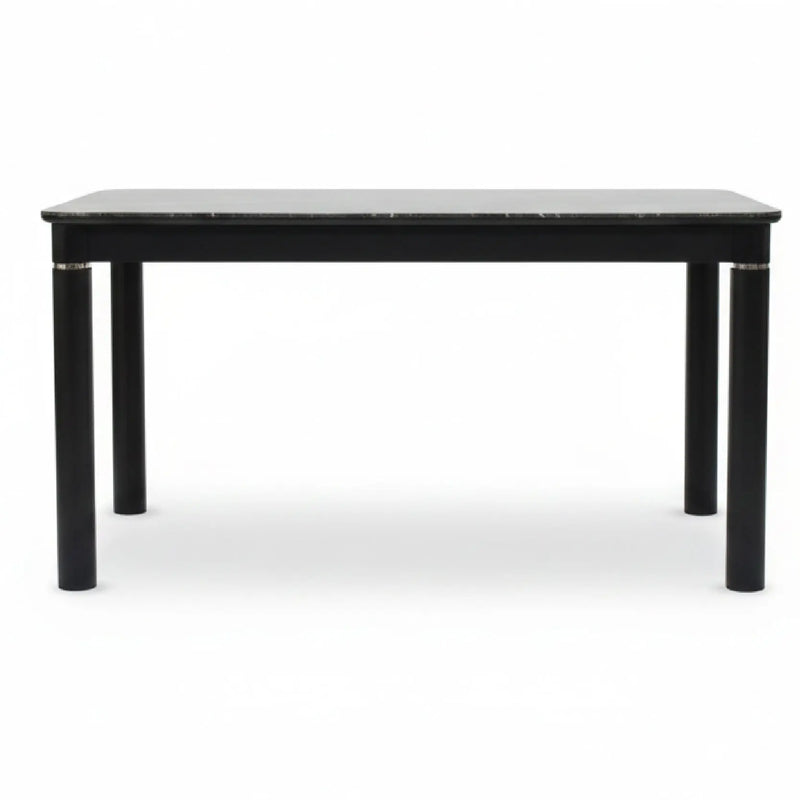 Black dining table with marble top on a white background