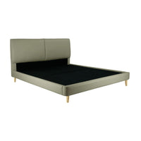 Green upholstered bed with black mattress on a white background