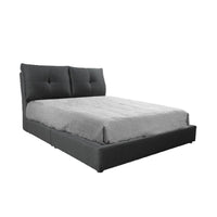 Gray upholstered bed with tufted headboard on a white background