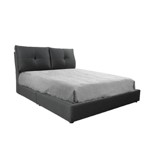 Gray upholstered bed with tufted headboard on a white background