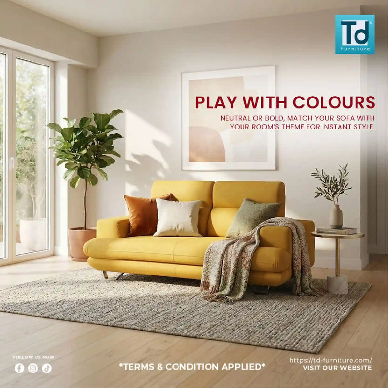 Yellow sofa in a living room with decor elements and TD Furniture logo.