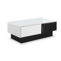 Modern coffee table with white and black design on a white background