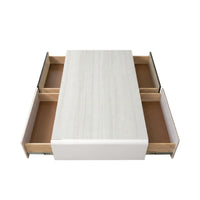 White bed frame with open drawers on a white background