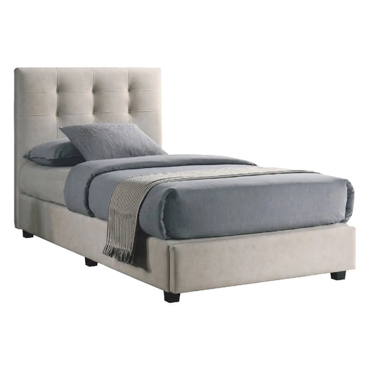 Beige upholstered bed with gray bedding on a white background