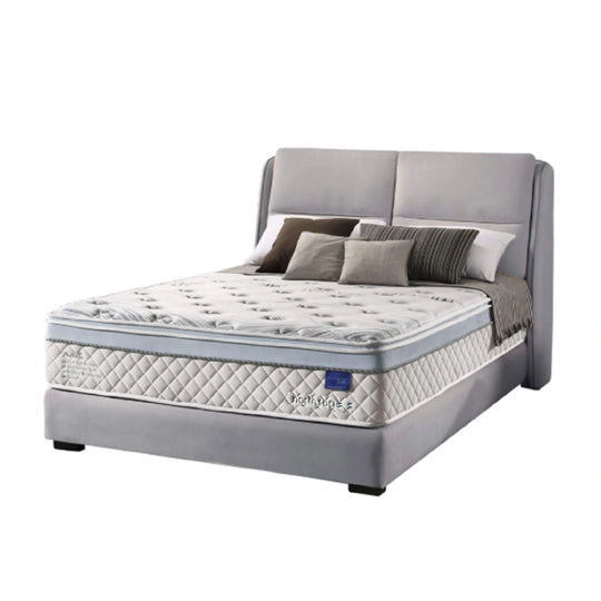 Gray upholstered bed with a mattress and pillows on a white background