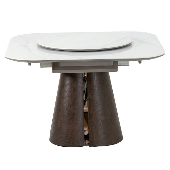 Dining table with white top and dark wooden base on a white background