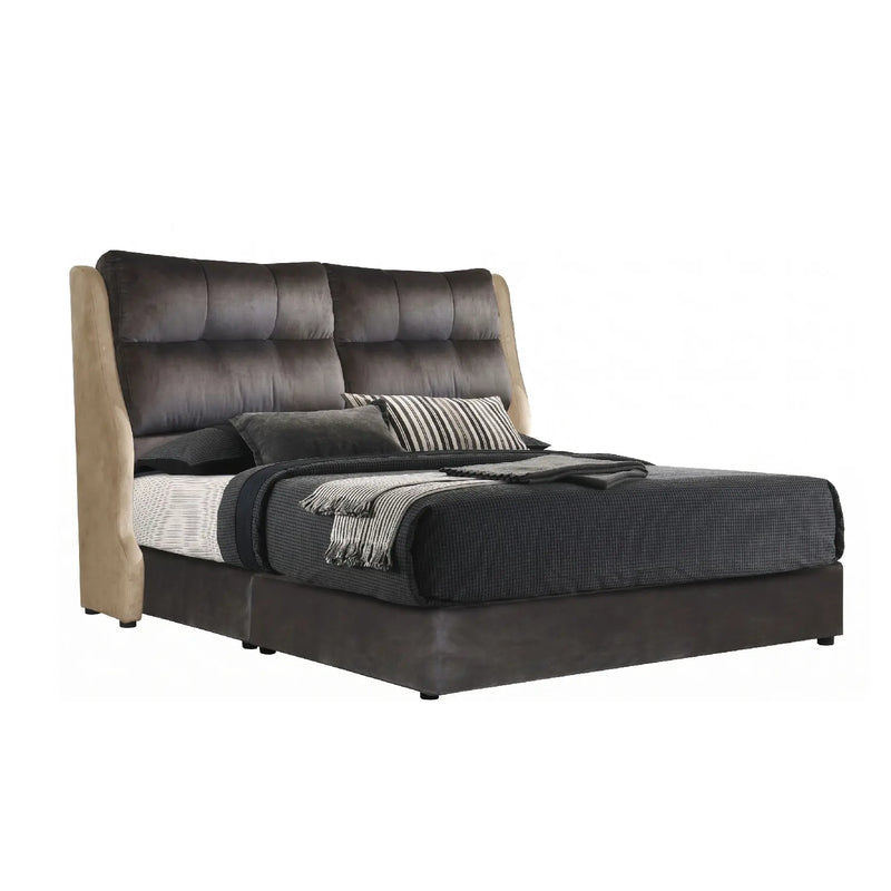Modern bed with dark upholstered headboard and bedding on a white background