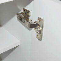 Metal cabinet hinge on a white door