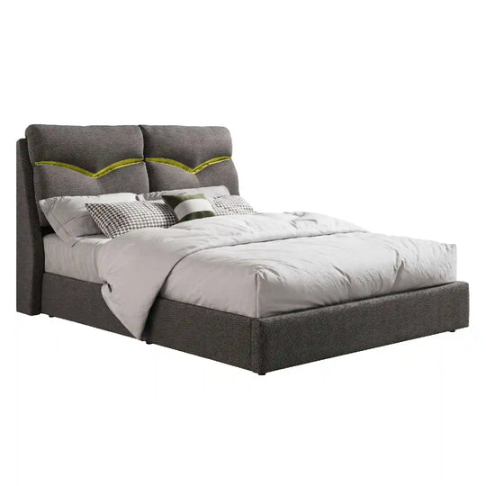 Gray upholstered bed with white bedding on a white background