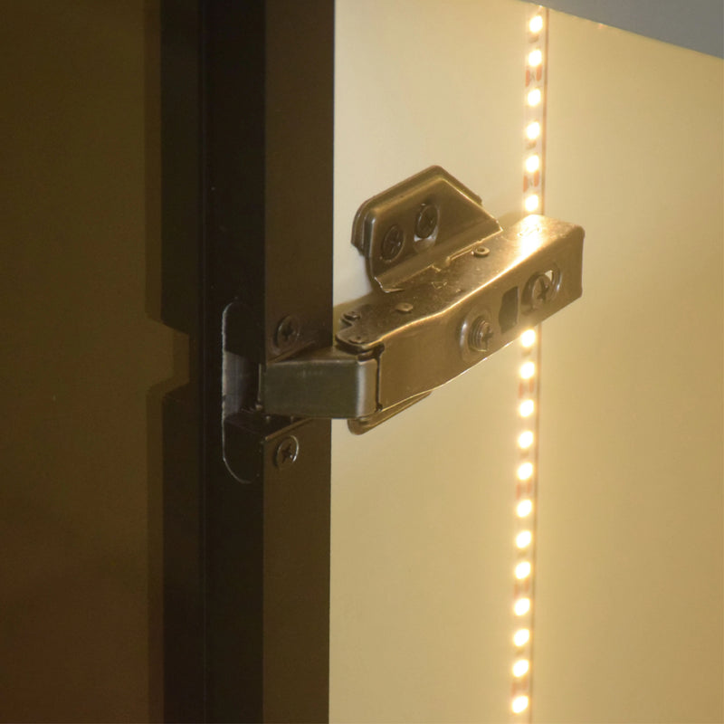 Close-up of a metallic hinge on a door with LED strip lighting.