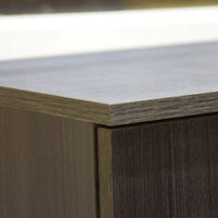 Close-up of a wooden furniture corner with a light-colored top.