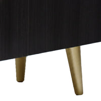 Close-up of a black table with gold legs on a white background
